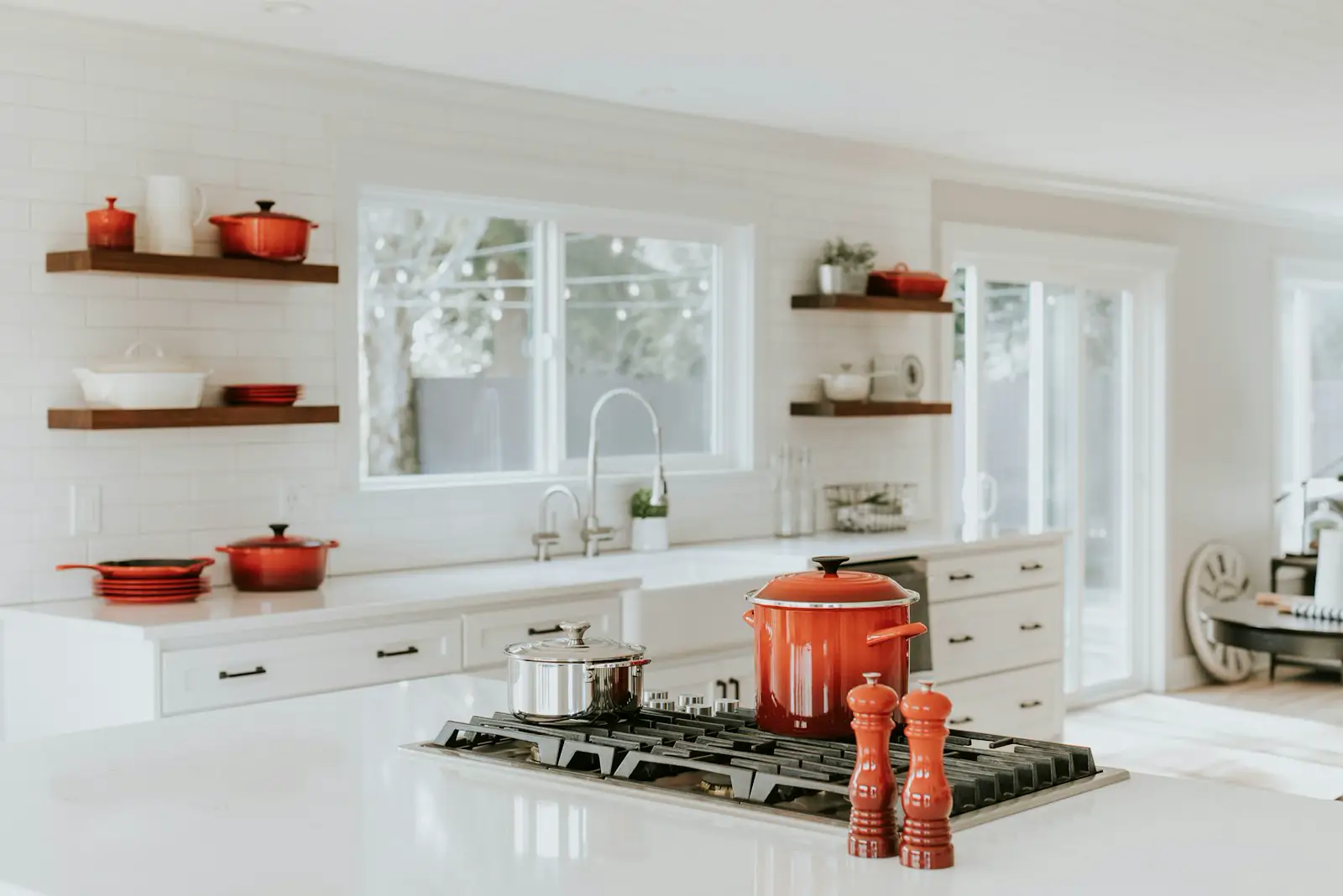 A white kitchen with a gas cooktop set into the island. Shown on the Cabinet storage page for Rockford, IL.